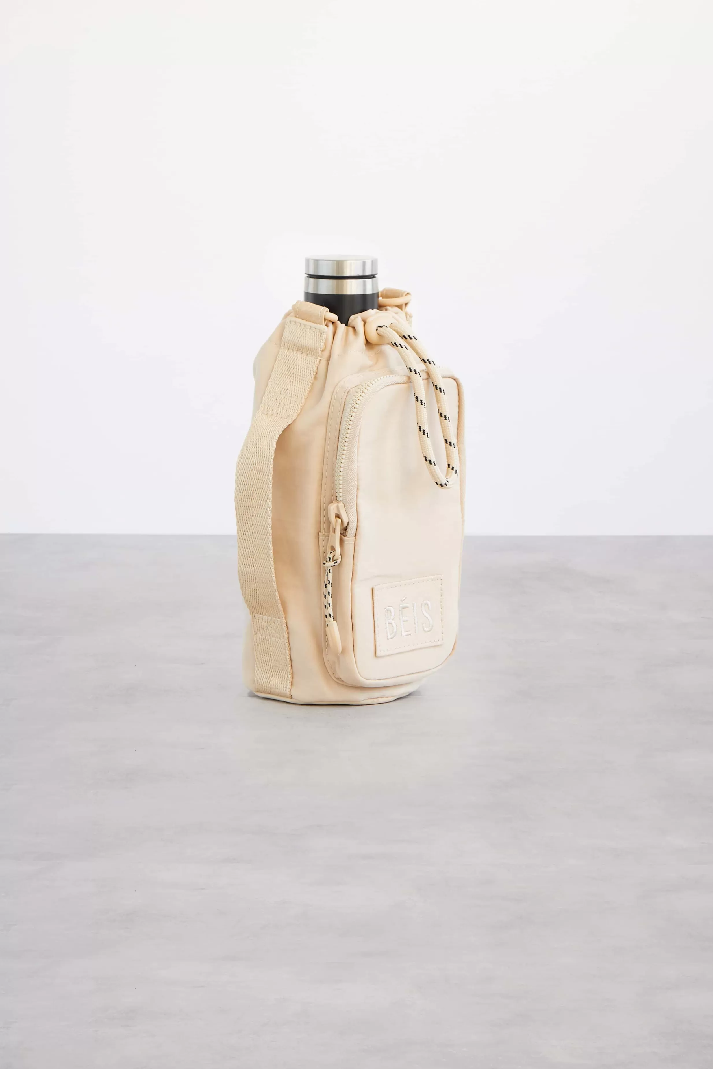 New The Water Bottle Sling In Beige Active Bags